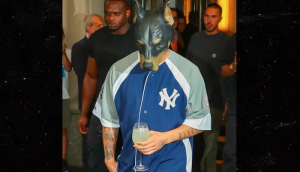Drake Seen Leaving Hotel in Dog Mask, Carrying Glass of Wine