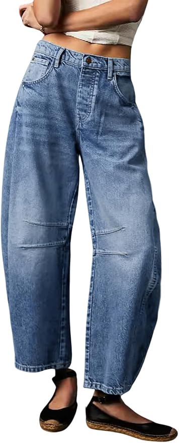 Wide-leg barrel-fit jeans in medium blue wash, shown from front on a model. Features high-rise waist with button closure, front pockets, and curved seam detail across the thighs. Relaxed, roomy silhouette tapering at the ankle.
