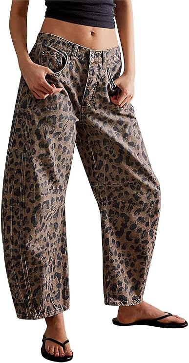 Wide-leg barrel-fit jeans in a tan and dark brown leopard print, shown on a model from waist to ankle. Features a mid-rise waist, relaxed baggy silhouette, visible front pockets, and contrast stitching.